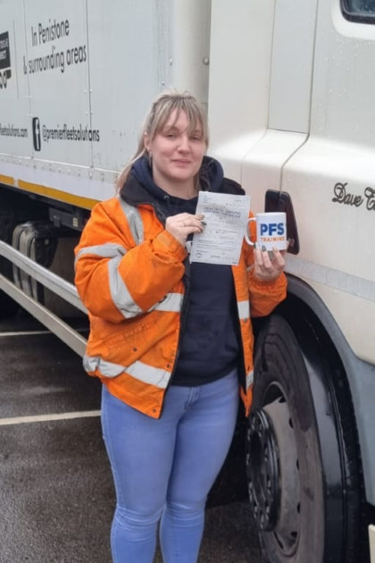 Woman holding pass cerificate for HGV Driver Training Category C with PFS Training