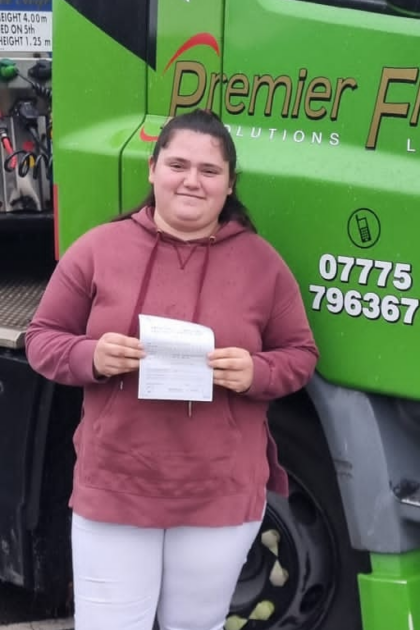 Woman holding pass cerificate for HGV Driver Training Category C+E with PFS Training